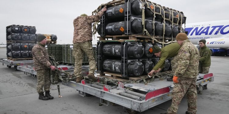Ukrainian servicemen unpack Javelin anti-tank missiles, delivered as part of the United States of America's security assistance to Ukraine, at the Boryspil airport, outside Kyiv, Ukraine, Friday, Feb. 11, 2022. British Prime Minister Boris Johnson said Thursday the Ukraine crisis has grown into "the most dangerous moment" for Europe in decades, while his top diplomat held icy talks with her Moscow counterpart who said the Kremlin won't accept lectures from the West. (AP Photo/Efrem Lukatsky)